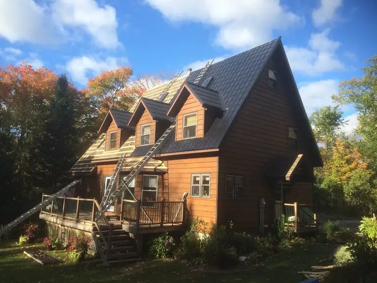 Steel tile roof panels part-way through an install